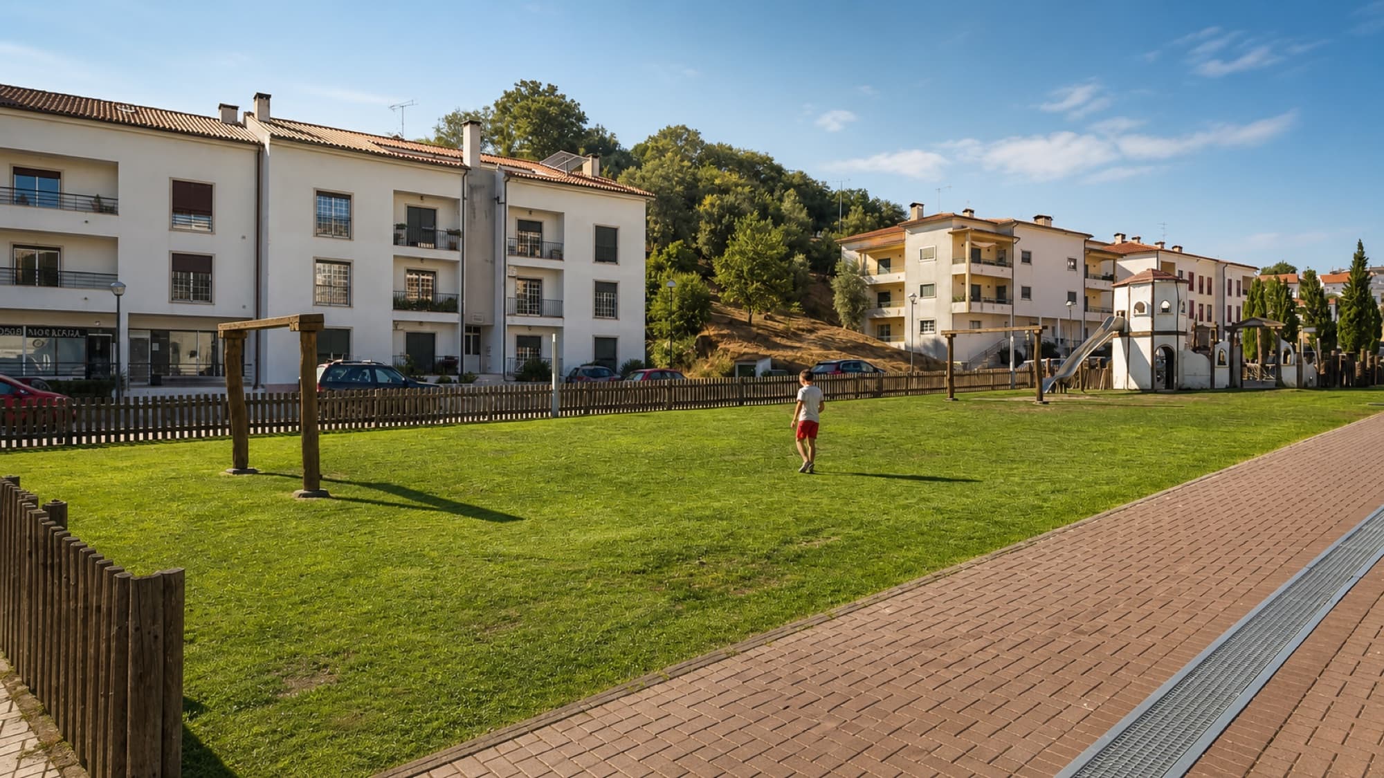 A child crossing the lawn at Parque das Águas Romanas in Penela